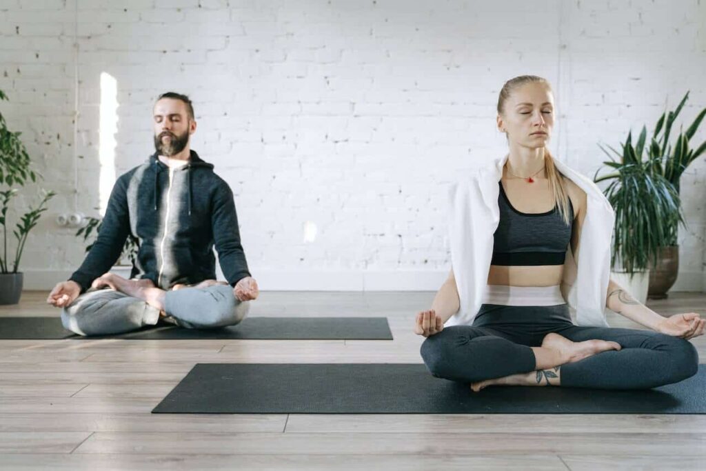 A man and women focussing on the breath during a point of focus meditation.
